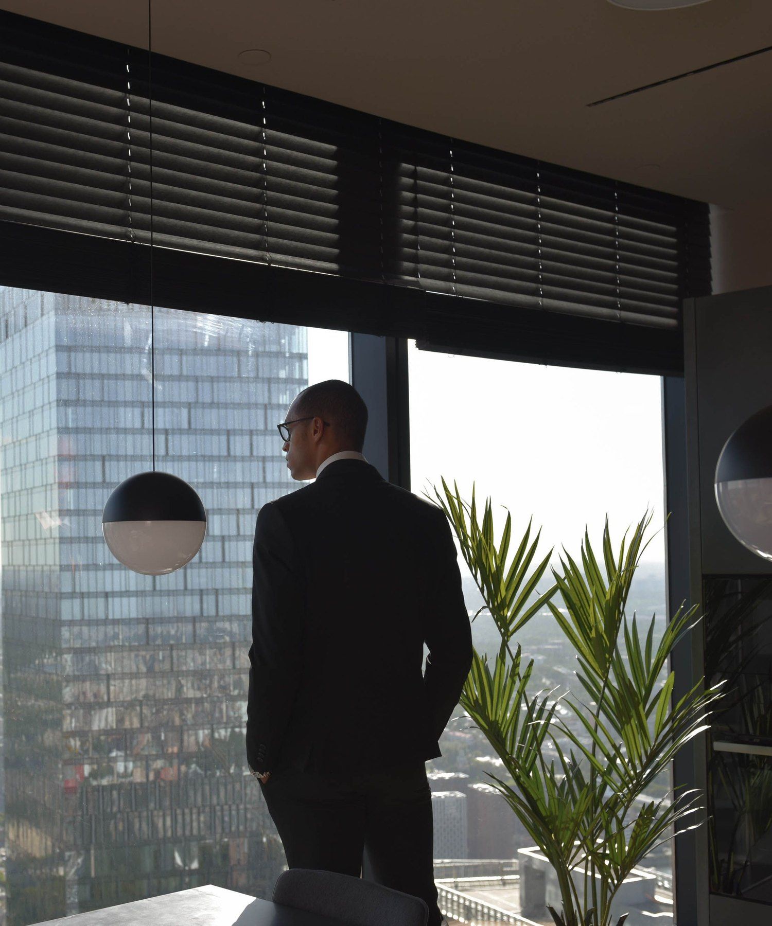 An executive looking out over the city from a high-rise office