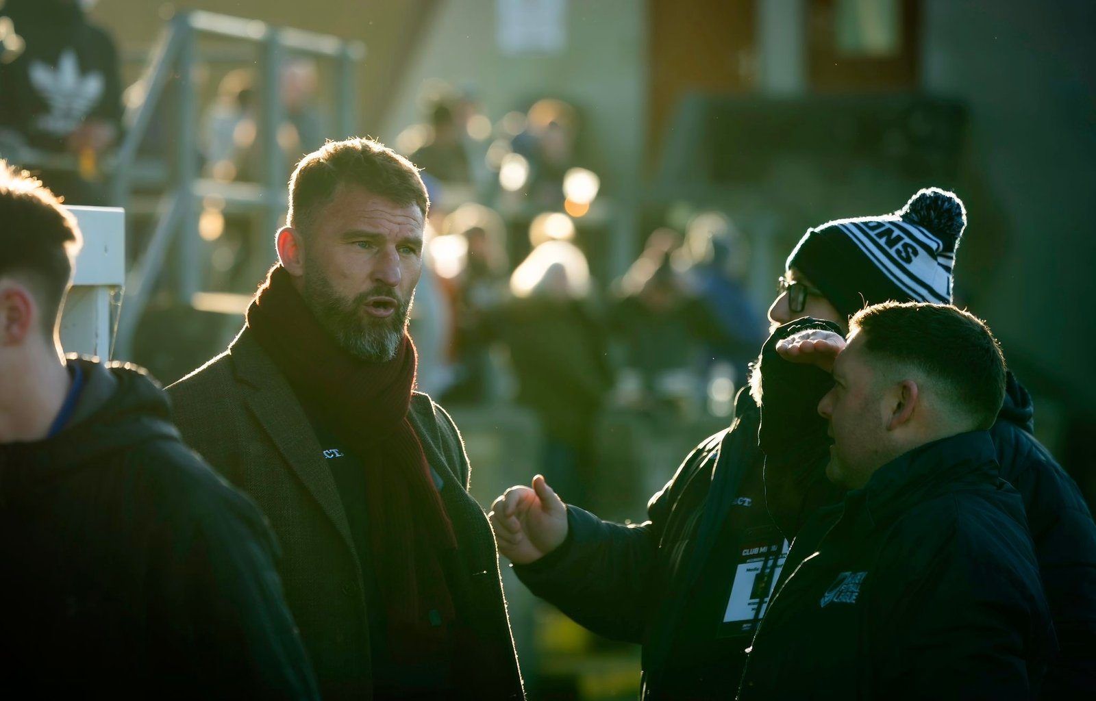 Paul Wood talking with coaches pitchside at a rugby league match