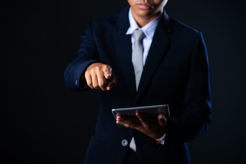 businessman using tablet analysing sales data and economic growth