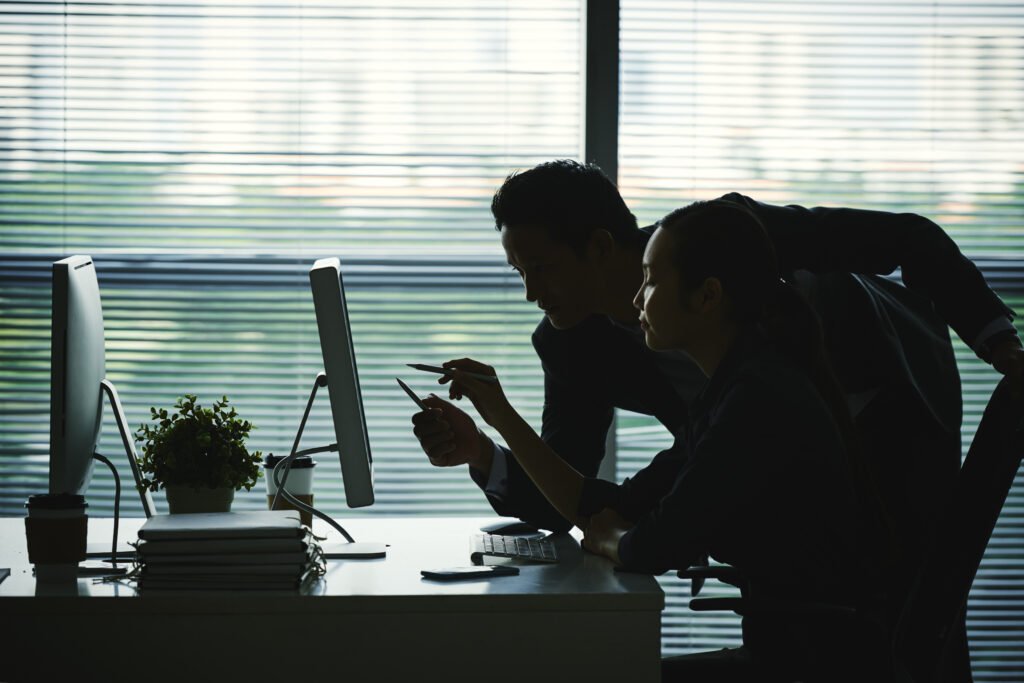 man and woman working dark silhouettes