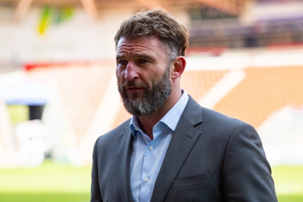 Paul Wood stood in a suit in a rugby stadium